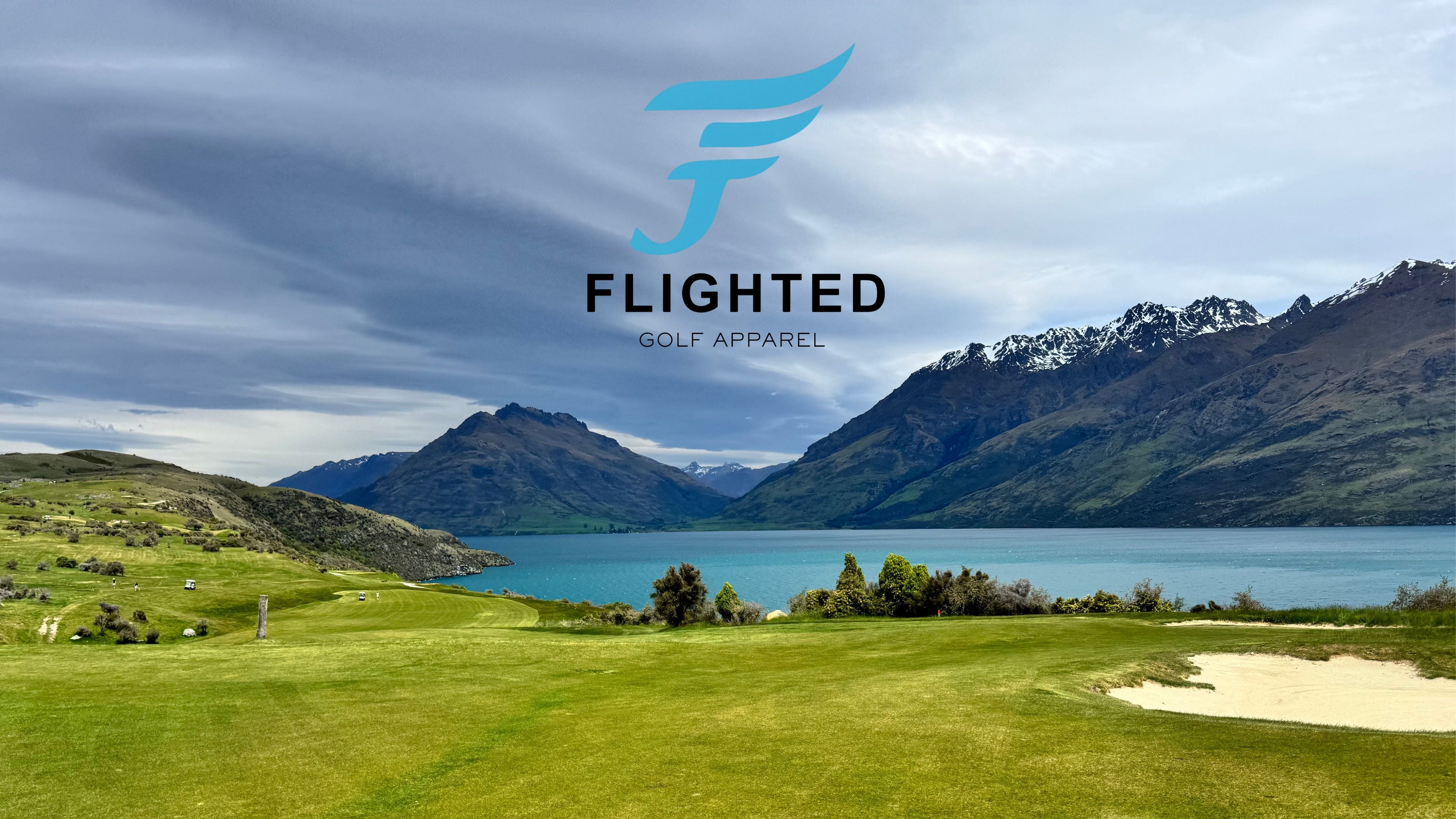 Golf course with mountains and lake in the background, featuring the Fligthed logo.