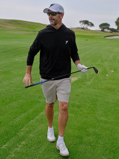 Man on a golf course holding a golf club